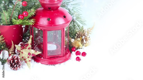 Red lantern and candle, falling snow. Christmas background
