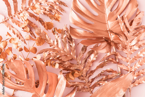 Flat lay of golden pink tropical leaf design elements. Decoration elements fo...