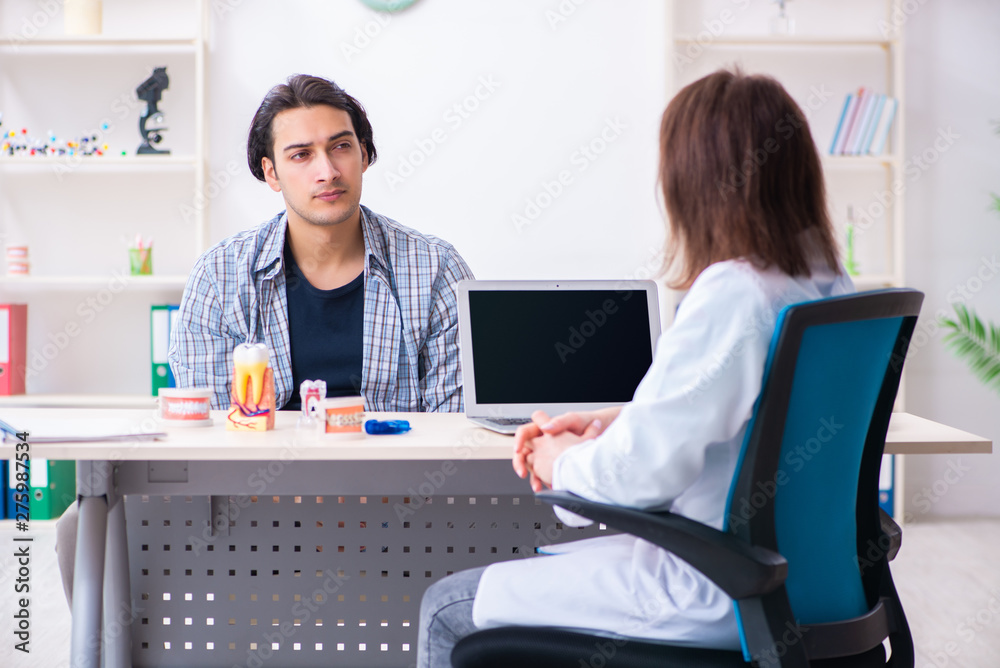 Fototapeta premium Young man visiting female doctor stomatologist