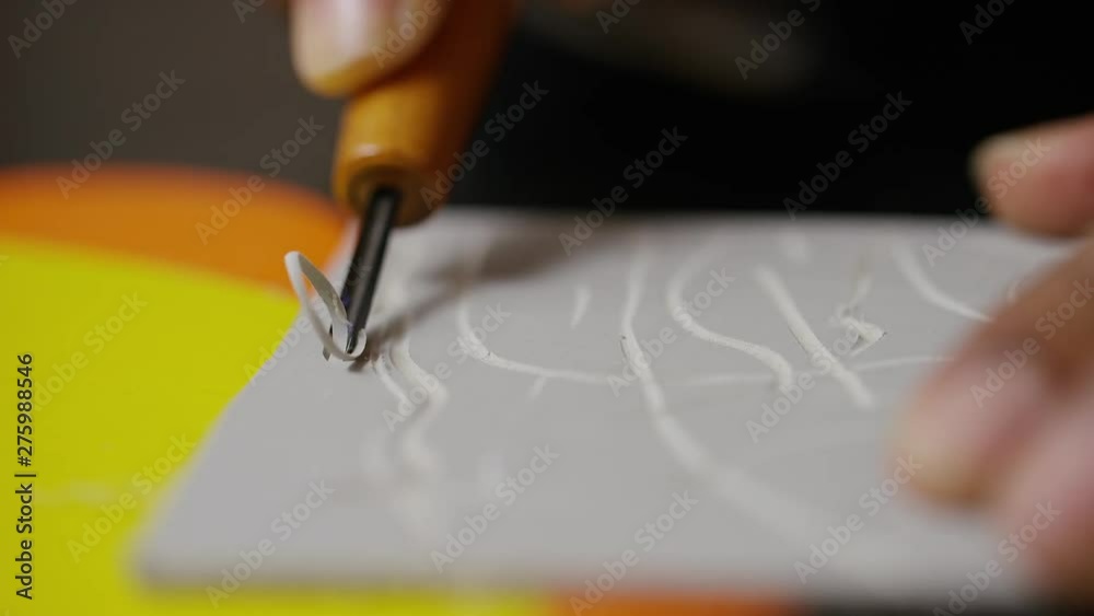 Close up of a linocut tool being used for lino printing