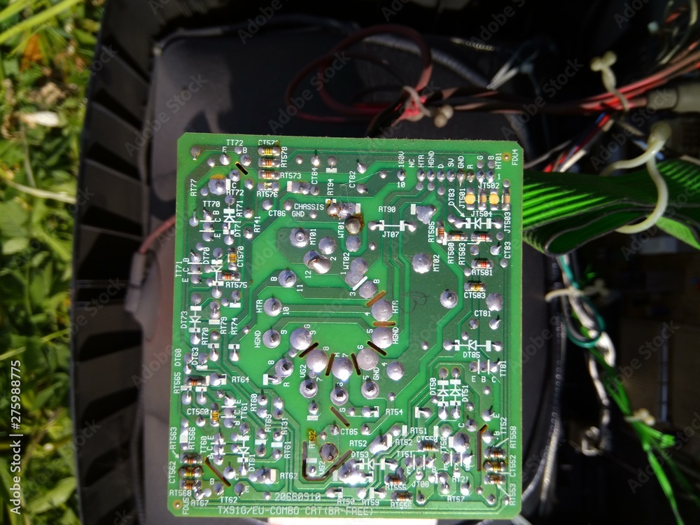 old green TV chip on green grass background
