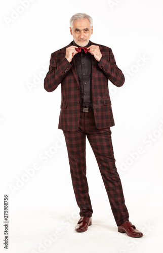 Portrait of old caucasian businessman. Senior man in elegant dark red suit on white isolated background