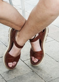 Female feet in summer with brown sandals