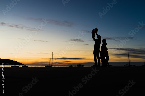 Silhouette of family by the evening sea