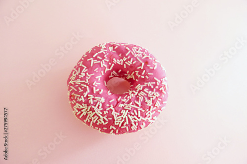 Juicy Pink Sprinkled Donut isolated on a Pink Background