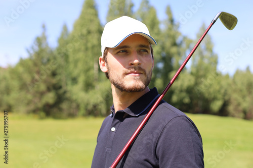 Man playing golf on beautiful sunny green golf course.
