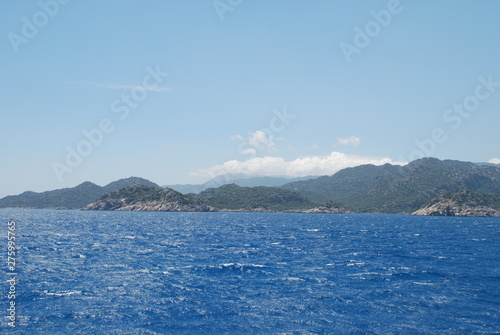Beautiful view of the Mediterranean Sea and rocky shore under the blue sky