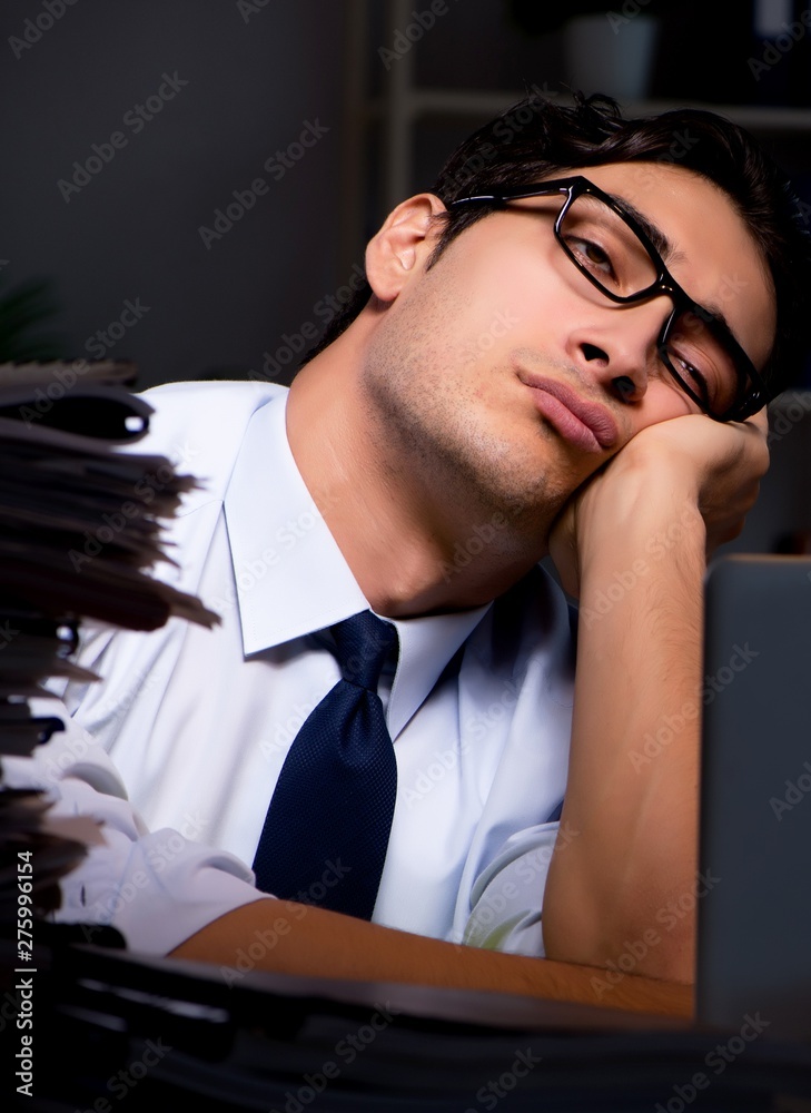 Young businessman working overtime late in office Young businessman working overtime late in office