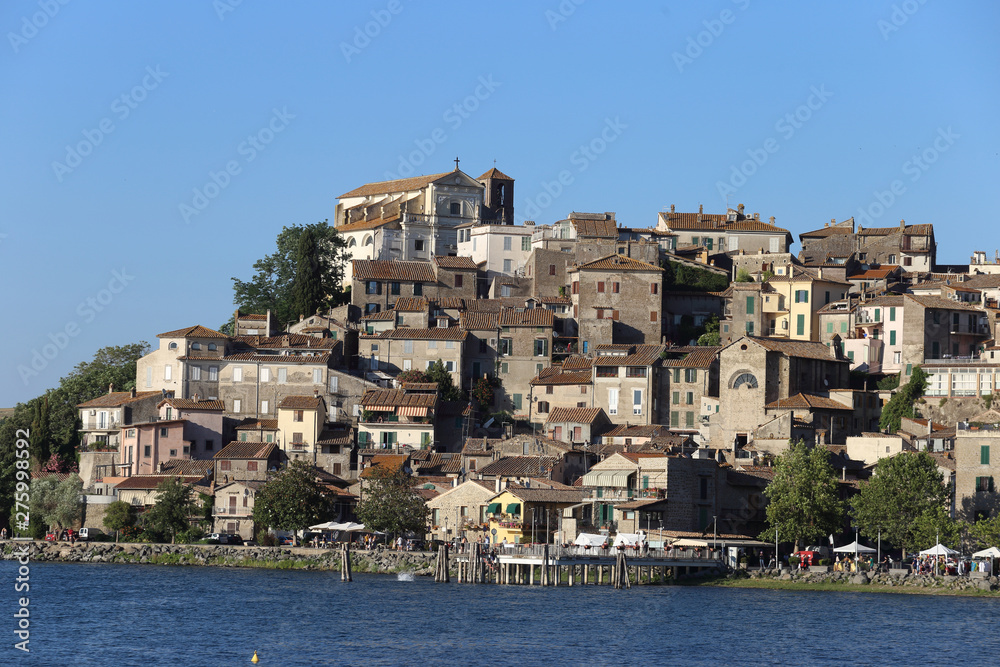 Anguillara Sabazia, Italy - 30 June 2019: The town and Lake Bracciano with tourists