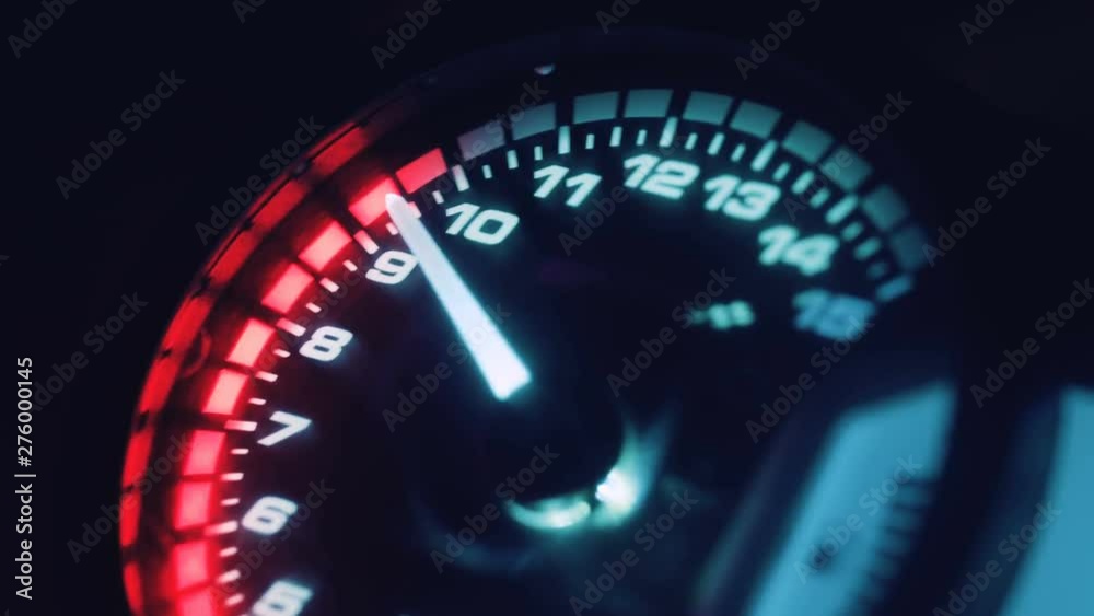 Close-up arrow speedometer of sports bike at high speed. Motorcycle dashboard. Racing in the night city. Night rider. Close-up arrow speedometer of sports bike at high speed. Motorcycle dashboard. Racing in the night city. Night rider.