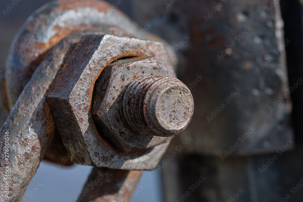 Rusty bolt with a nut in the mounting post Rusty bolt with a nut in the mounting post