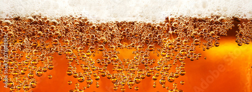 Beer detail.Cold lager beer drink with bubbles and drops photo