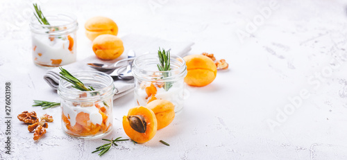 Fototapeta Naklejka Na Ścianę i Meble -  Natural yogurt with pieces of apricots and rosemary