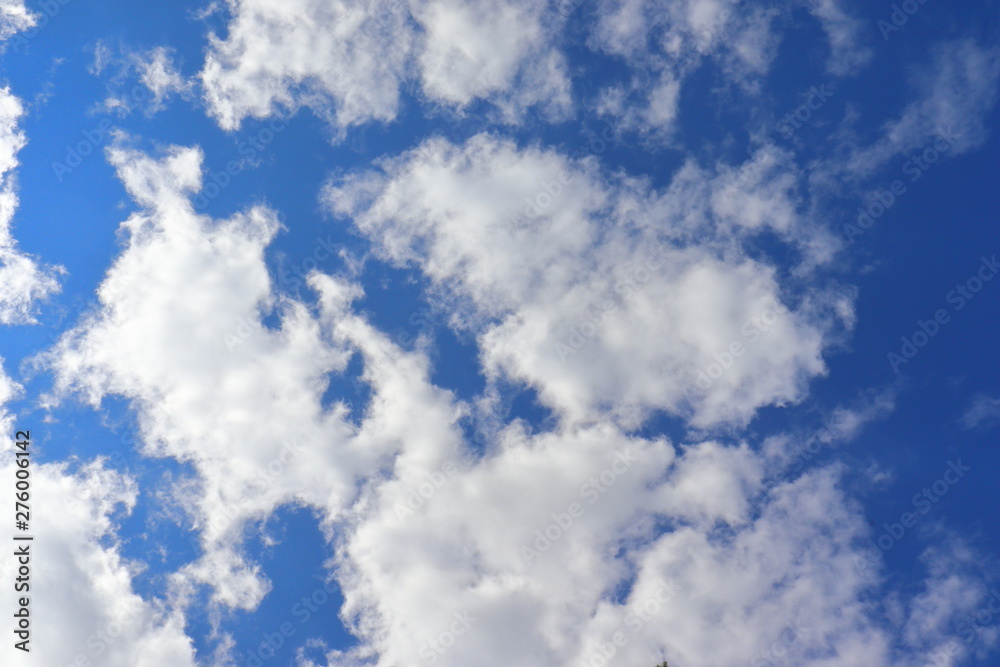 Obraz premium Blue sky background with clouds in summer.