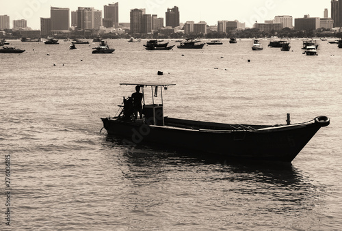 An old and small boat in front of the coast of Pattaya
