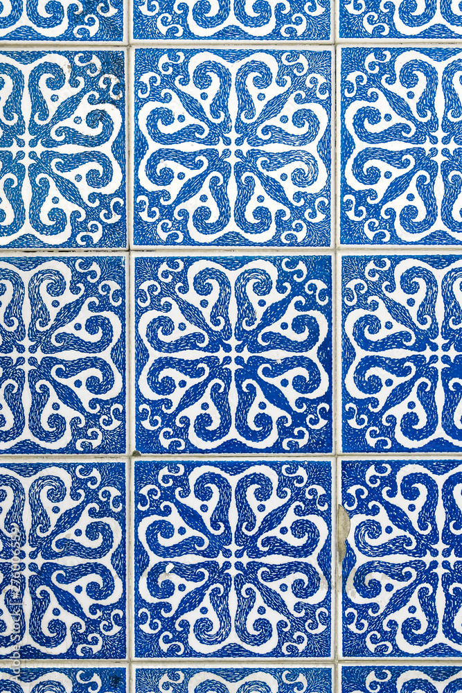Detail of traditional portuguese tiles pattern with blue ornaments. Detail of traditional tiles from the facade of an old house in Porto, Portugal. Traditional Portugal pottery. Multicolor design.
