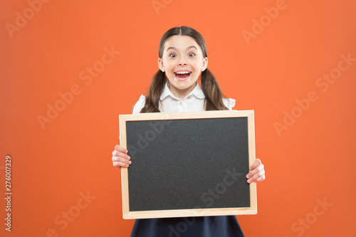 happy childhood. school market sales. signage. cheerful school girl with blackboard. happy pupil in school uniform. copy space. commercial marketing conept. business school advert. new shopping idea
