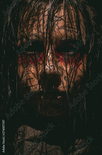 Infernal girl with black eyes and cracked skin close-up portrait