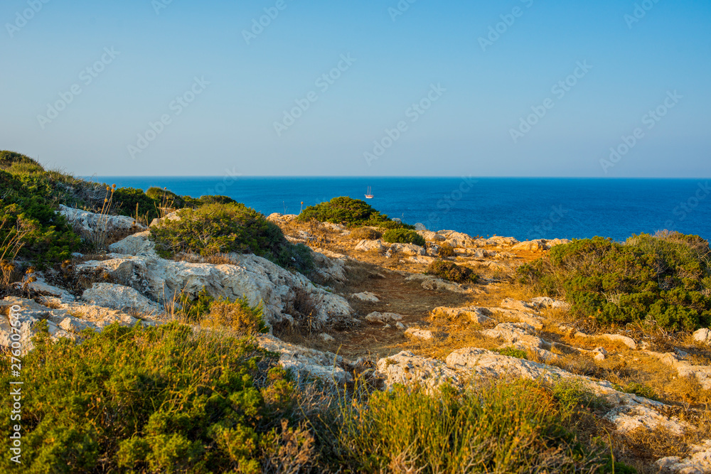  beautiful panoramic view of Cape Cavo Greco, filled with the gentle sunset sun