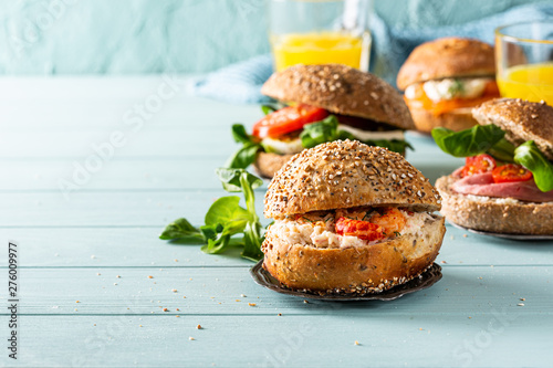 фотографія Sandwiche with crab salad and shrimp, multigrain bun on blue wooden background