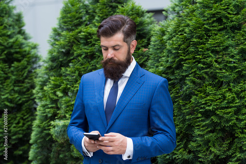 Application for business. Man formal suit use social networks application. Guy surfing internet. Online service and application. Modern technologies. Businessman well groomed man hold smartphone