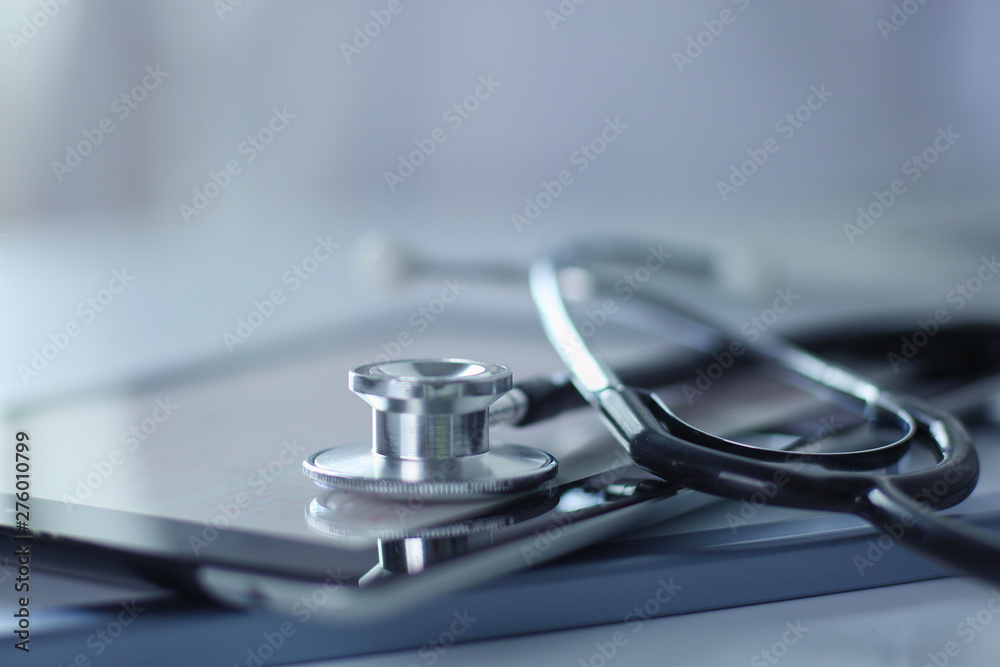 Medical equipment: blue stethoscope and tablet on white background. Medical equipment - obrazy, fototapety, plakaty 