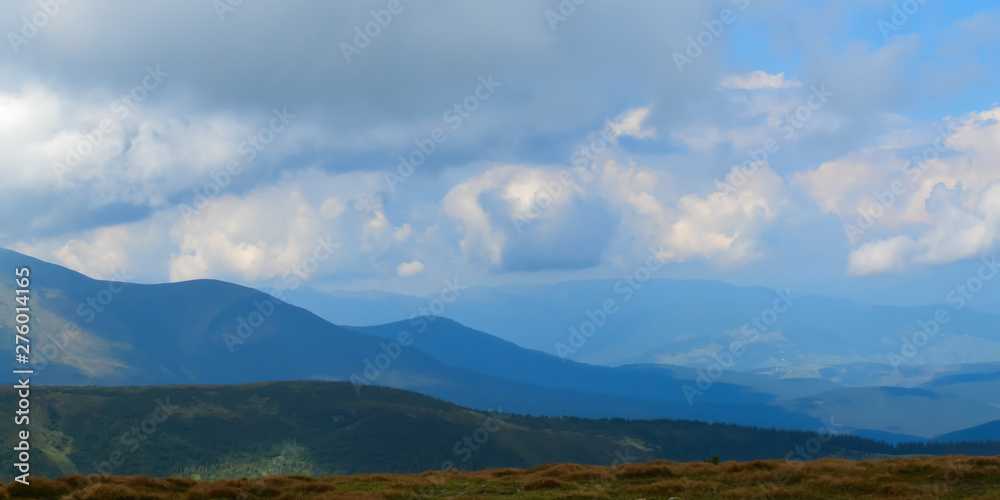 Obraz premium Panoramic view on thunderstorm clouds from Hoverla, Carpathian mountains, Ukraine. Horizontal outdoors shot