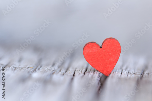 Wooden background with red heart, place for text