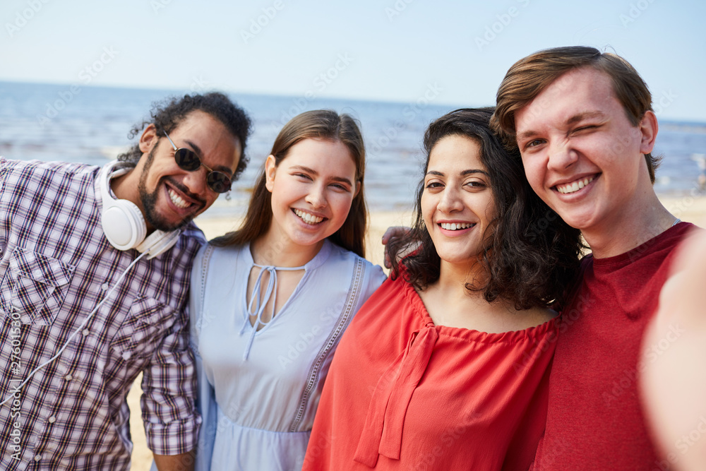 Group of happy young people posing at beach enjoying Summer, copy space Group of happy young people posing at beach enjoying Summer, copy space