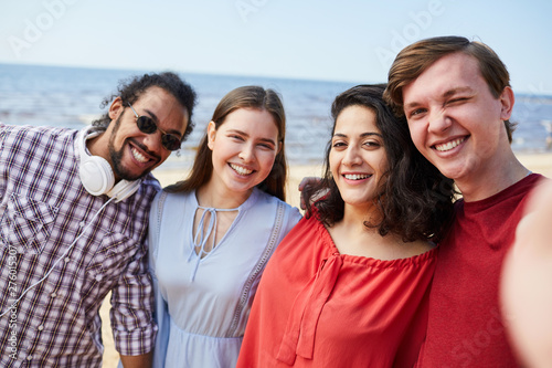 Group of happy young people posing at beach enjoying Summer, copy space