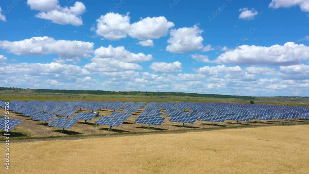 solar panels at the field with the beautiful clouds at sunny summer day aerial view solar panels at the field with the beautiful clouds at sunny summer day aerial view