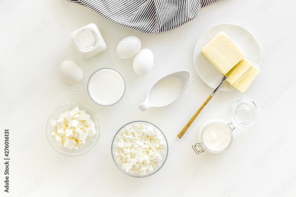 Fototapeta premium Eggs, butter, milk, yougurt, cottage for natural farm products yougurt on white background top view monochrome pattern