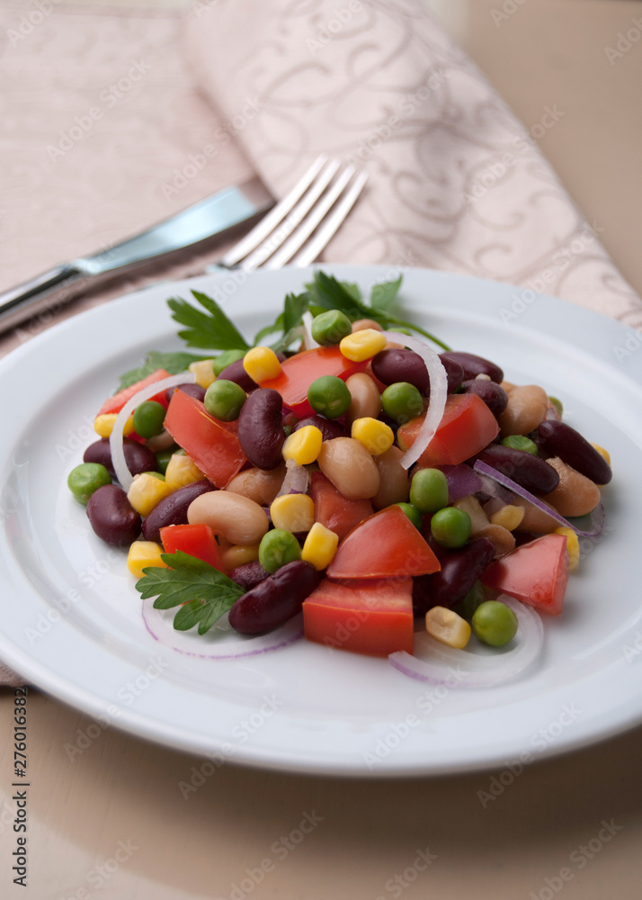 Healthy bean and corn salad on a white plate