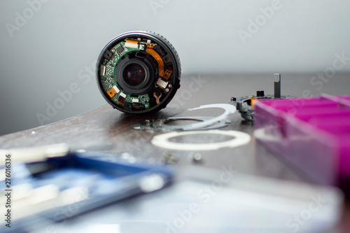 the broken lens lies on the repair stand with the tools, replaces the broken photographic equipment, copy the space