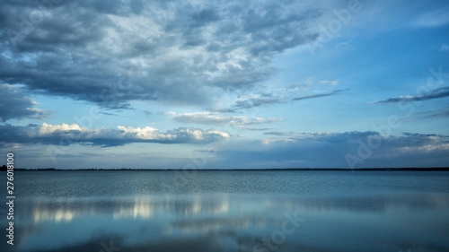 Beautiful blue background. Clouds reflected on the water. Switiaz Lake. Polesie. Ukraine © Szymon Bartosz