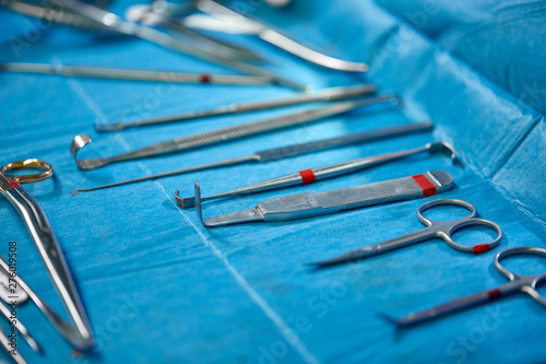 Surgical instruments and instruments, including scalpels, forceps and forceps, located on the table for surgery. Medicine, surgery, saving lives.