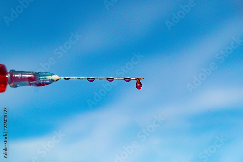 Type of medical syringe with red liquid photo