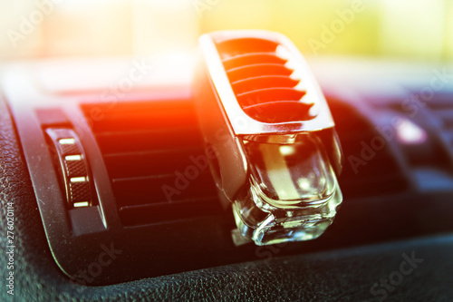 Air freshener in the car, black interior, car deflectors, sunlight shines through the windshield