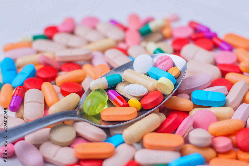 spoon filled with a variety of medications in a plate spoon filled with a variety of medications in a plate