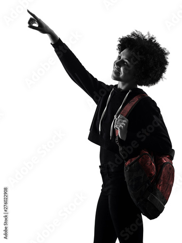 one mixed race african young teenager girl woman looking up pointing in studio shadow silhouette isolated on white background