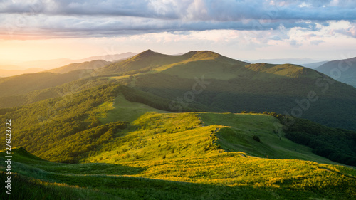 Stunning summer sunrise in the mountains. Beautiful green alpine meadow and blue sky. Polonina Wetlinska. Bieszczady. Poland