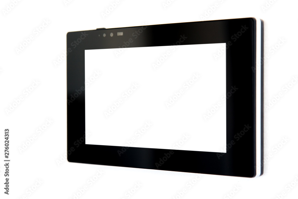 touchscreen tablet with a blank white screen and a black case mounted on a white wall to control smart home technology, close-up side view. touchscreen tablet with a blank white screen and a black case mounted on a white wall to control smart home technology, close-up side view.