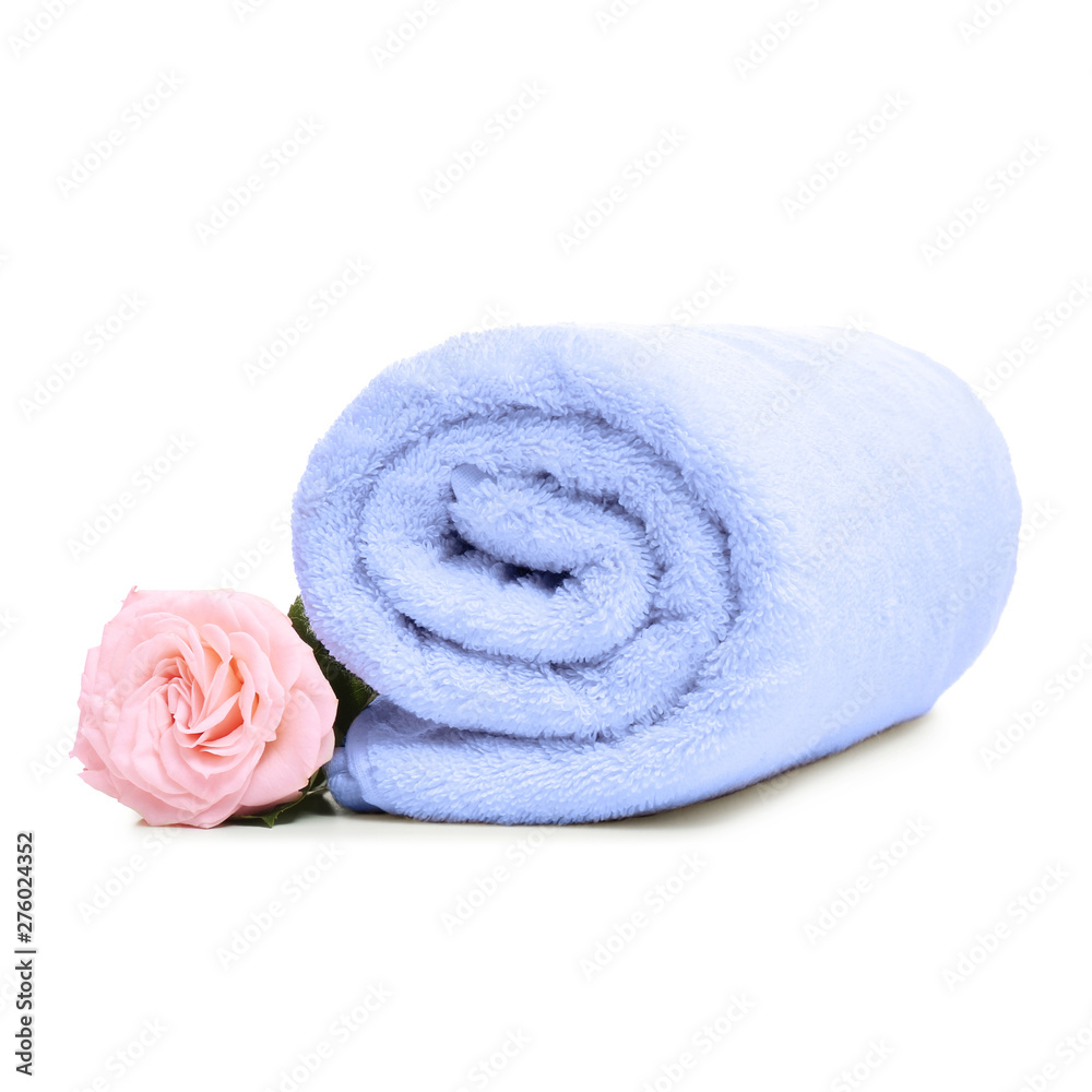 Clean rolled towel with flower on white background Clean rolled towel with flower on white background