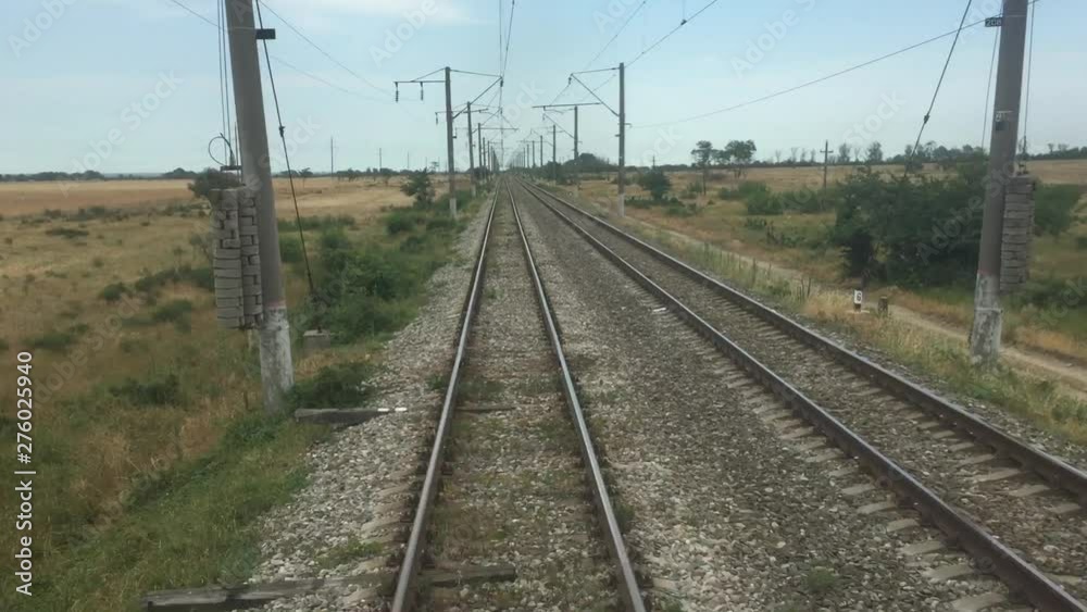 Journey by train. First-person view of Railway train trip in Russia. Beautiful view to a picturesque green landscape from the window of the moving train. Journey by train. First-person view of Railway train trip in Russia. Beautiful view to a picturesque green landscape from the window of the moving train.