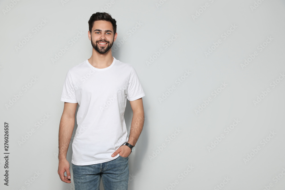 Young man in t-shirt on light background. Mock up for design Young man in t-shirt on light background. Mock up for design