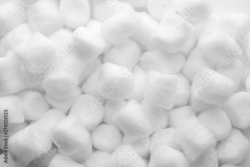 Soft clean cotton balls as background, top view