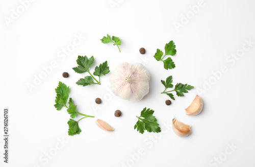 Flat lay composition with green parsley, pepper and garlic on white background