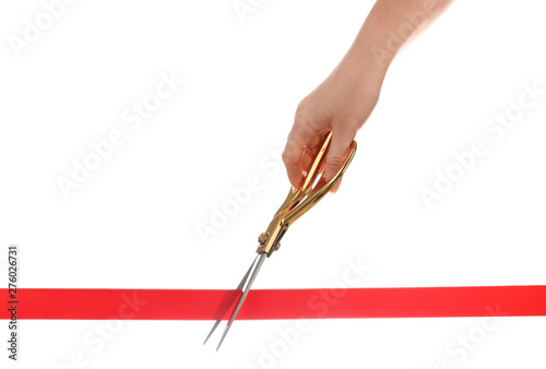 Woman cutting red ribbon with scissors on white background. Traditional ceremony