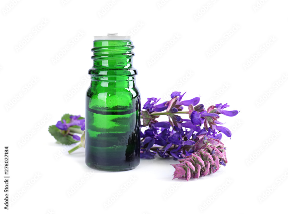 Bottle of herbal essential oil and sage flowers isolated on white