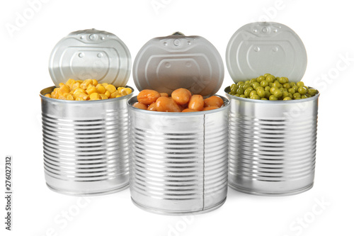 Open tin cans of peas, beans and corn kernels isolated on white